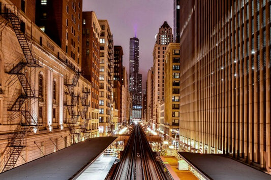 Our canvas print of a photograph capturing the elevated train tracks looking north down Wabash Avenue in Chicago is a stunning addition to any space. The black and white image captures the bustling energy of the city, with the train tracks leading the eye towards the iconic Chicago skyline in the distance. Bring a touch of urban energy to your home or office with this captivating piece of art.