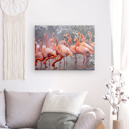 Add a touch of whimsy to your home decor with our canvas print of elegant flamingos standing in a tranquil pond amidst a wintry wonderland. This stunning piece of art is sure to transport you to a serene and magical place every time you gaze upon it.